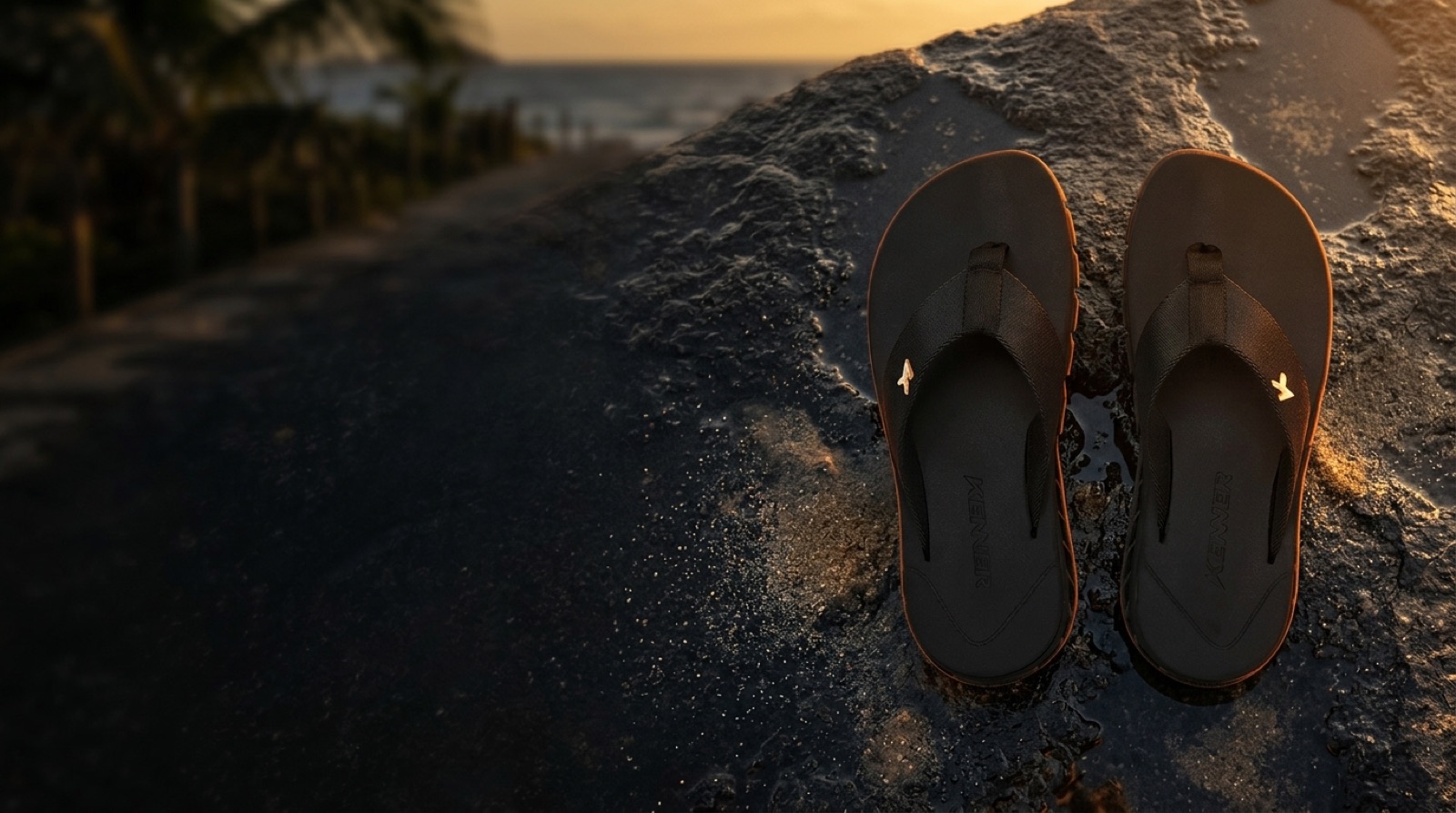 Chinelo Kenner na pedra ao pôr do sol